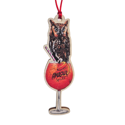 Wooden Christmas decoration of an owl and aperol spritz cocktail